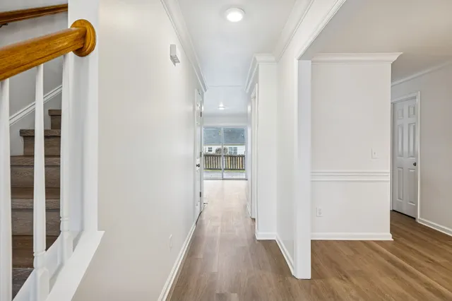 a view of a hallway with wooden floor