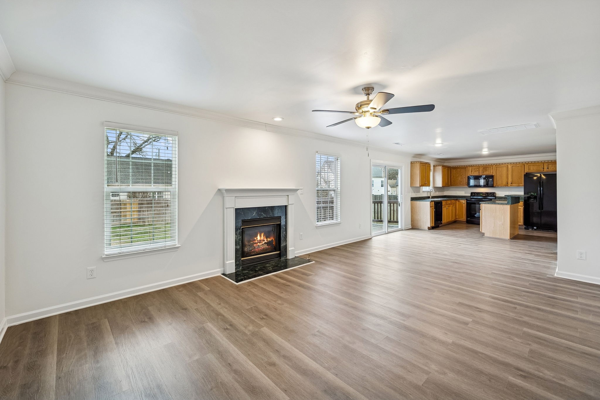 1849 Devon Drive Spring Hill, TN 37174 - Photo 15 of 58 an empty room with furniture a fireplace and wooden floor