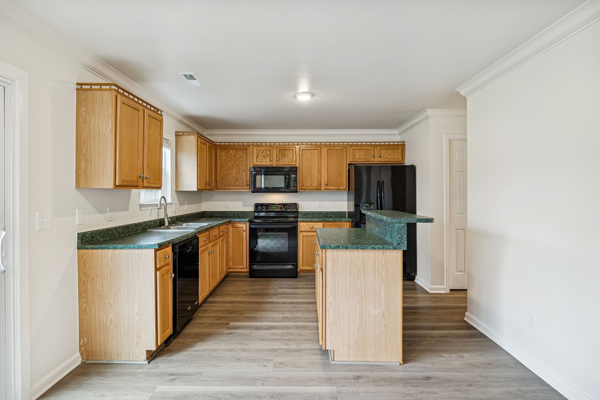 1849 Devon Drive Spring Hill, TN 37174 - Photo 20 of 58 a kitchen with stainless steel appliances kitchen island granite countertop a stove a sink and a refrigerator