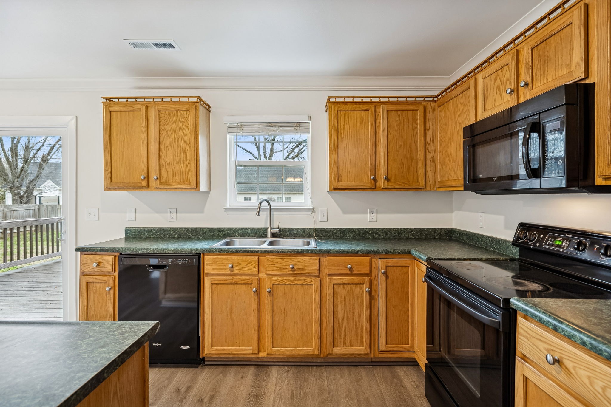 1849 Devon Drive Spring Hill, TN 37174 - Photo 22 of 58 a kitchen with stainless steel appliances granite countertop wooden cabinets and a stove top oven