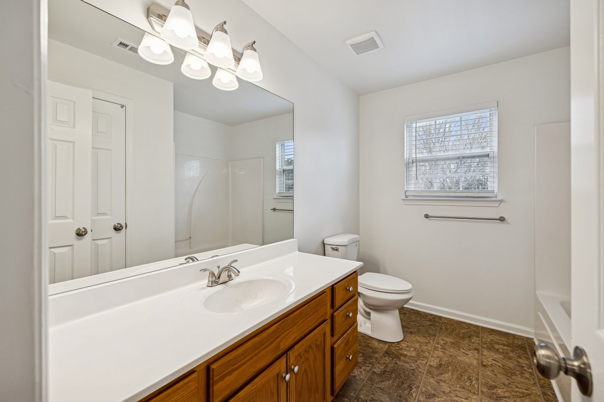 1849 Devon Drive Spring Hill, TN 37174 - Photo 34 of 58 a bathroom with a sink a toilet and a mirror