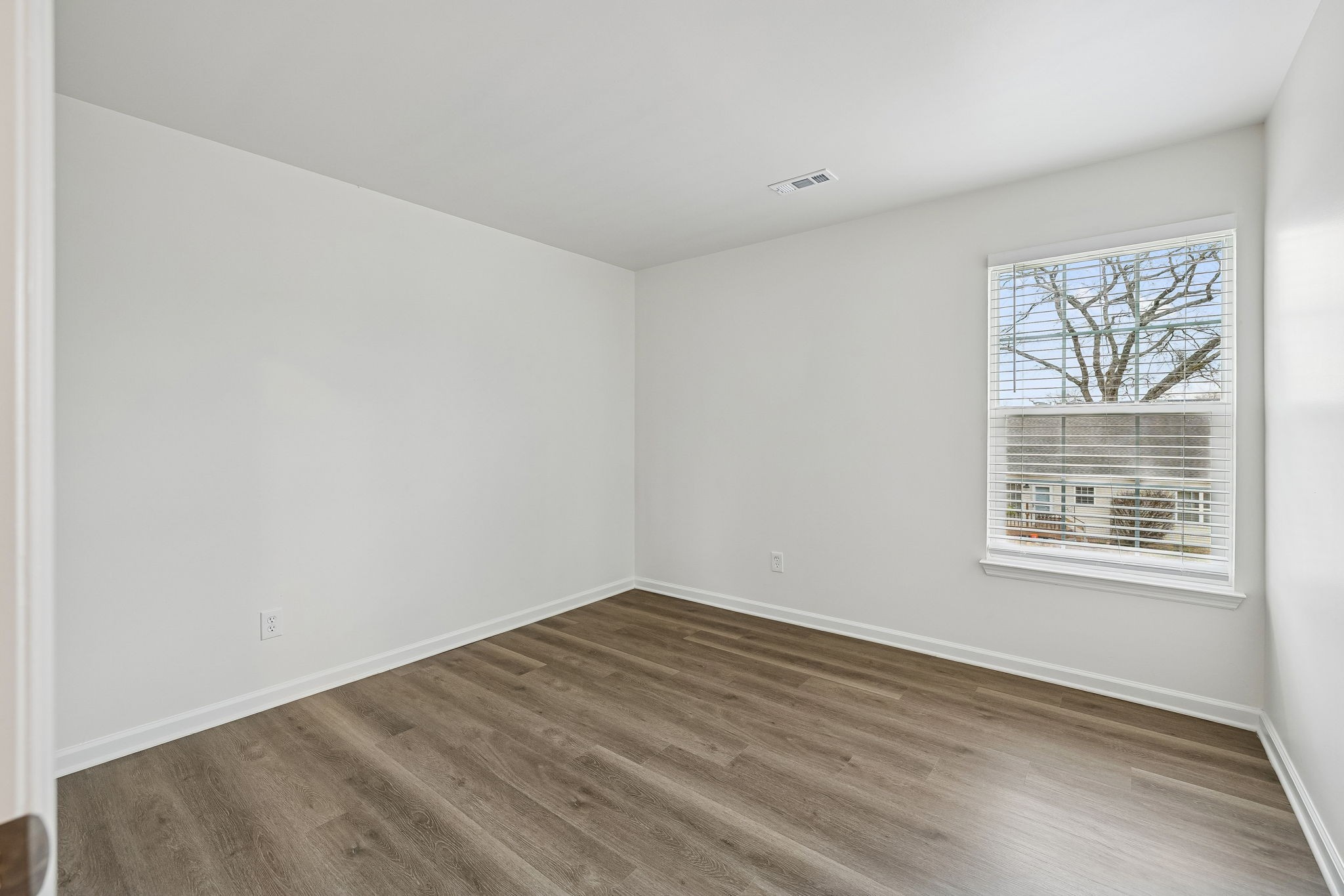 1849 Devon Drive Spring Hill, TN 37174 - Photo 39 of 58 a view of an empty room with wooden floor and a window