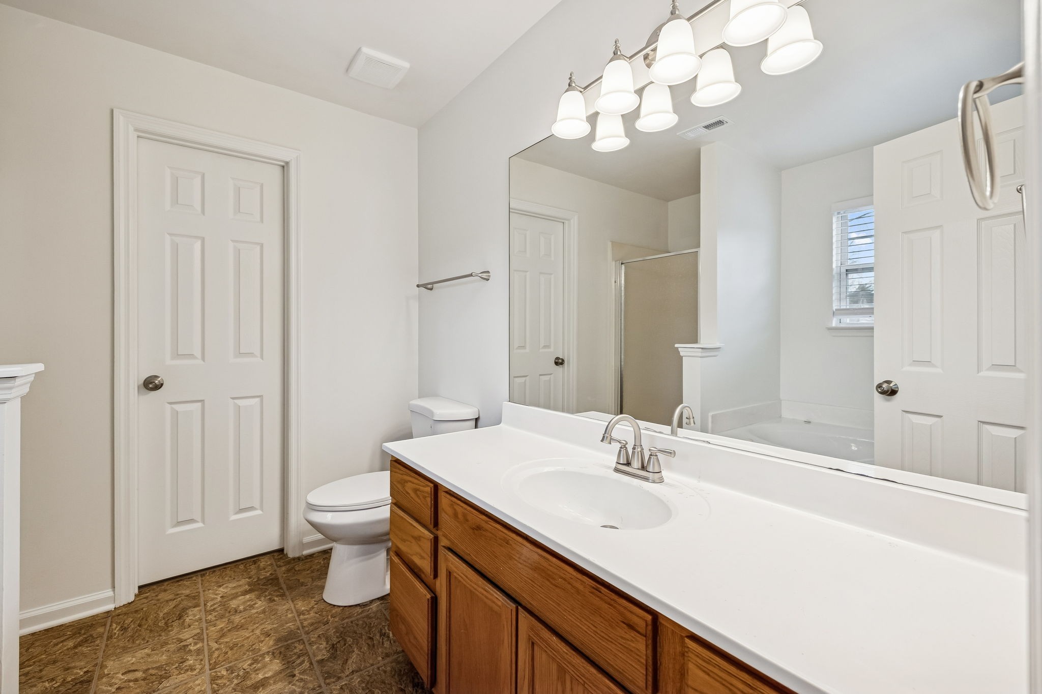 1849 Devon Drive Spring Hill, TN 37174 - Photo 44 of 58 a bathroom with a sink a toilet and a large mirror