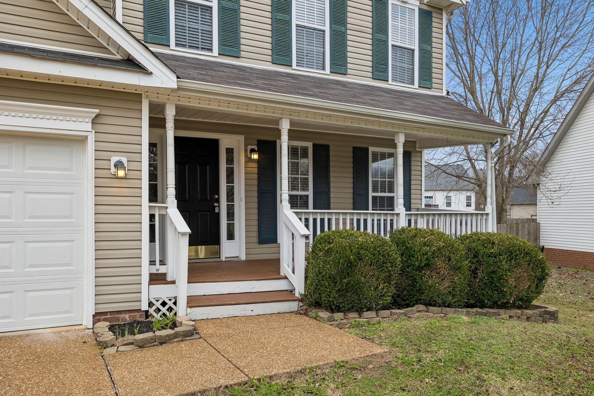 1849 Devon Drive Spring Hill, TN 37174 - Photo 7 of 58 a view of a brick house with plants and large windows