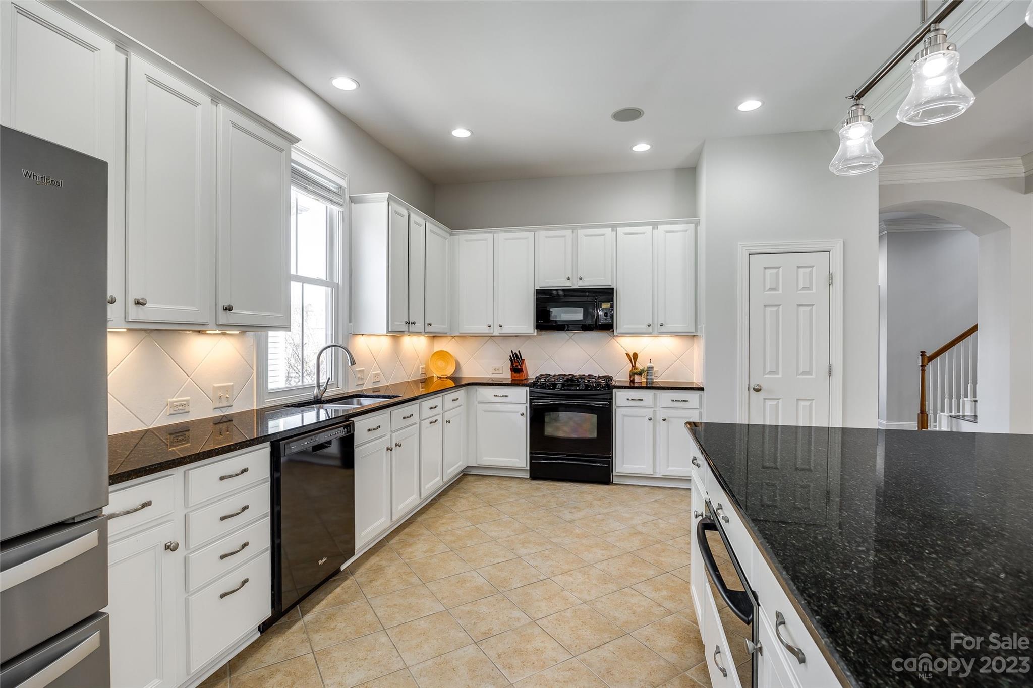 109 Mills Lane Fort Mill, SC 29708 - Photo 16 of 48 a kitchen with granite countertop a stove sink and cabinets