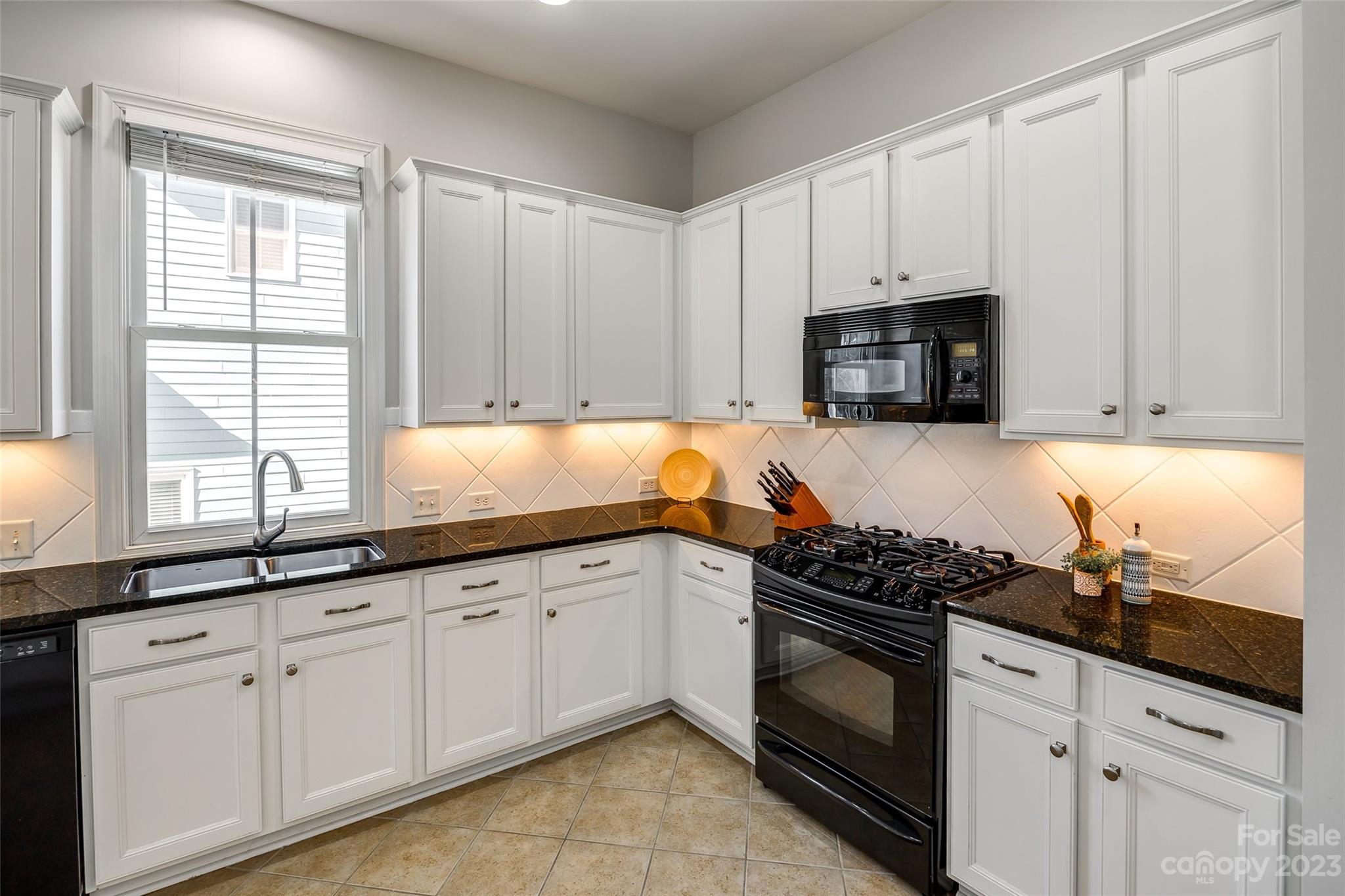 109 Mills Lane Fort Mill, SC 29708 - Photo 18 of 48 a kitchen with granite countertop white cabinets and white appliances