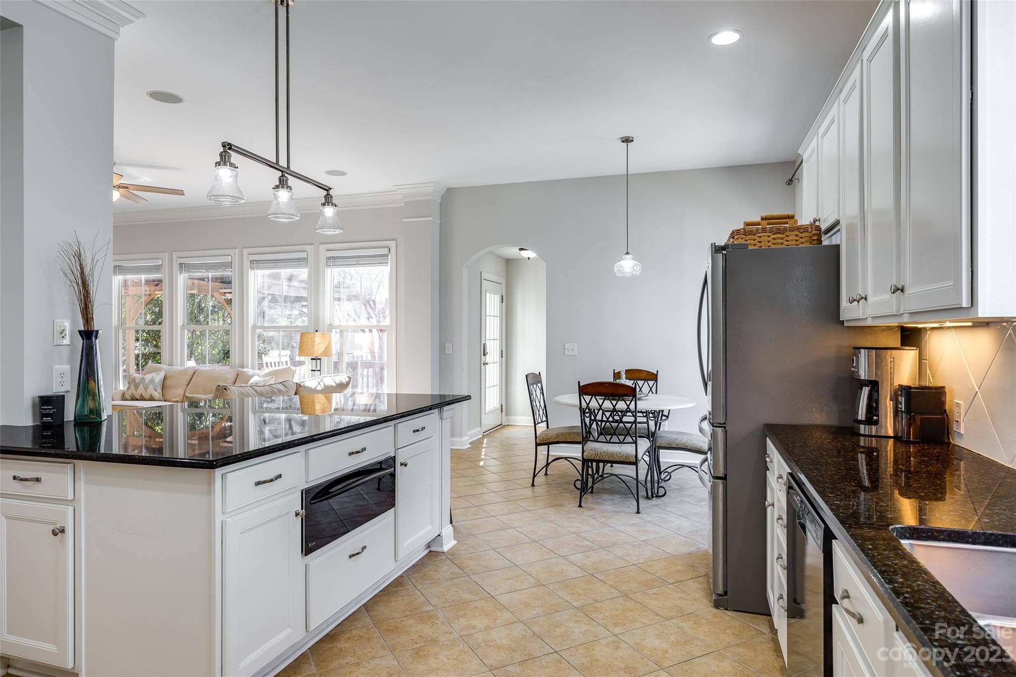 109 Mills Lane Fort Mill, SC 29708 - Photo 19 of 48 a kitchen with stainless steel appliances kitchen island granite countertop a stove a sink and a refrigerator