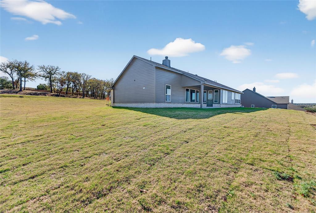 400 Hayden Faith Court Springtown, TX 76082 - Photo 32 of 35 a view of a house with yard and ocean view