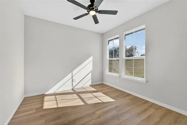 a kitchen with stainless steel appliances granite countertop white cabinets a refrigerator and a sink