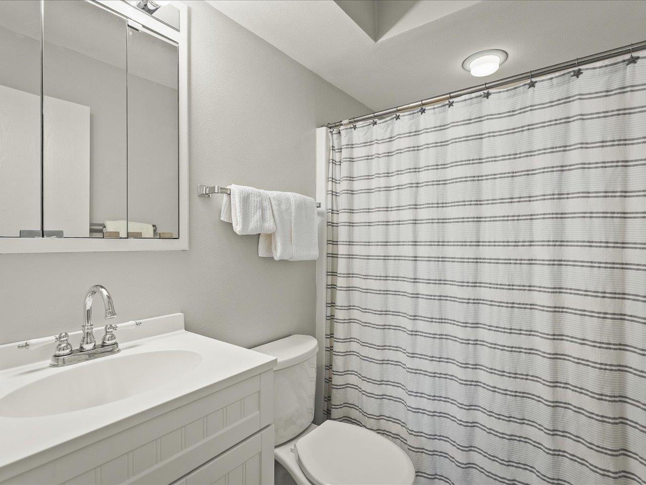 1919 Tomahawk Court Freeport, IL 61032 - Photo 26 of 39 a bathroom with a sink a toilet and shower curtain