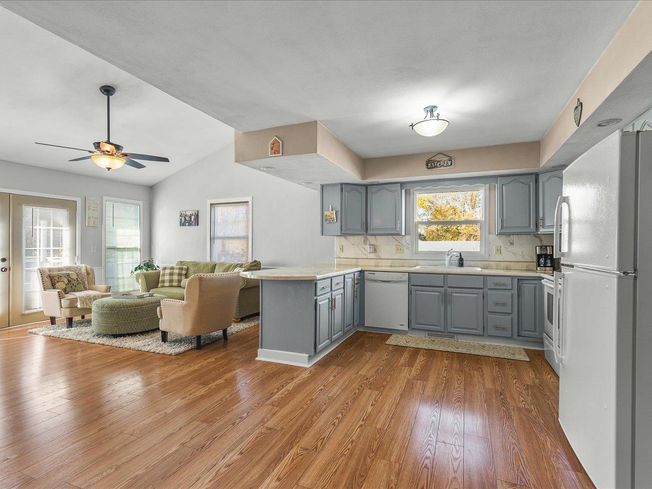 1919 Tomahawk Court Freeport, IL 61032 - Photo 9 of 39 a large kitchen with a wooden floor and cabinets