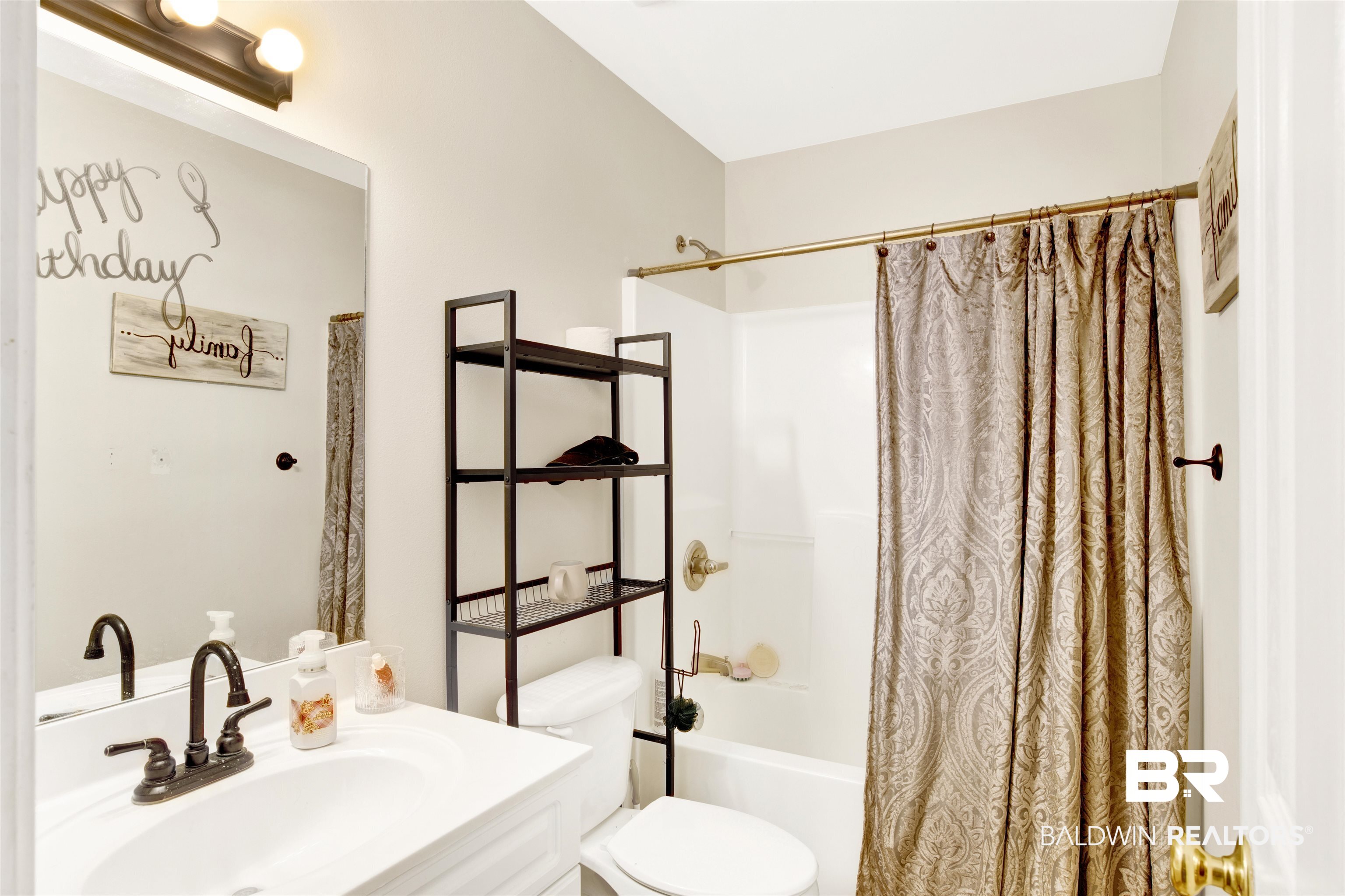 24384 Sailfish Lane Orange Beach, AL 36561 - Photo 12 of 23 Full bathroom featuring toilet, shower / tub combo with curtain, and vanity