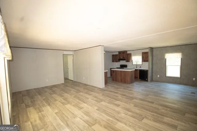 a view of a kitchen with a sink and a refrigerator