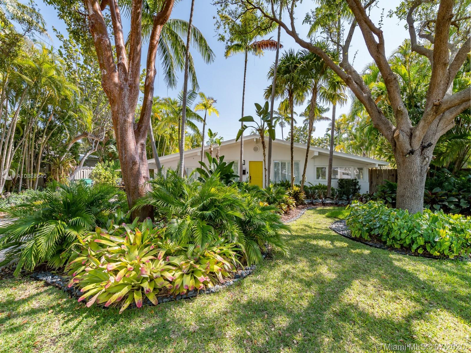 255 Glenridge Road Key Biscayne, FL 33149 - Photo 1 of 25 a backyard of a house with lots of green space