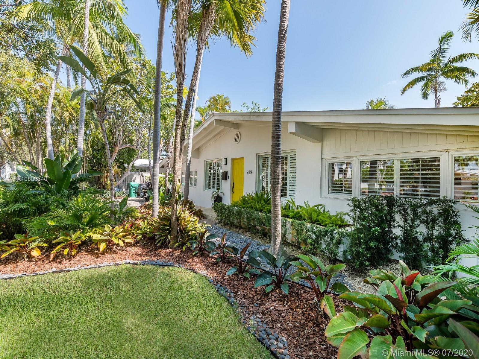 255 Glenridge Road Key Biscayne, FL 33149 - Photo 3 of 25 a front view of a house with garden