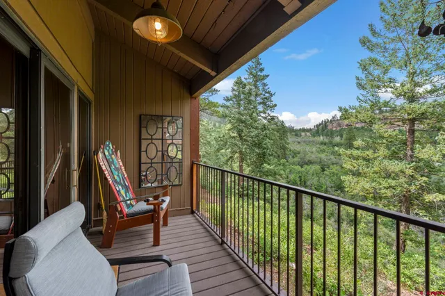 a view of a two chairs in the balcony