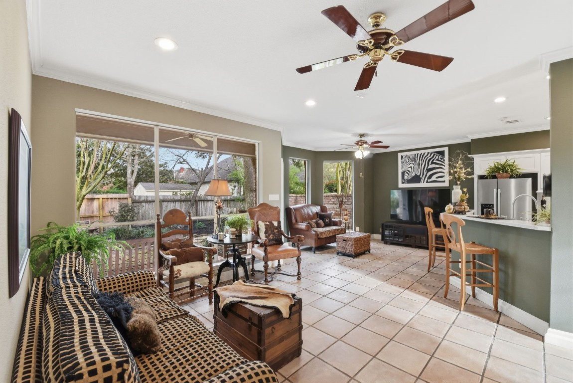 16322 Cranwood Drive Spring, TX 77379 - Photo 11 of 42 Step into the inviting living room and enjoy a stunning view of the lush backyard, blending indoor comfort with outdoor beauty.