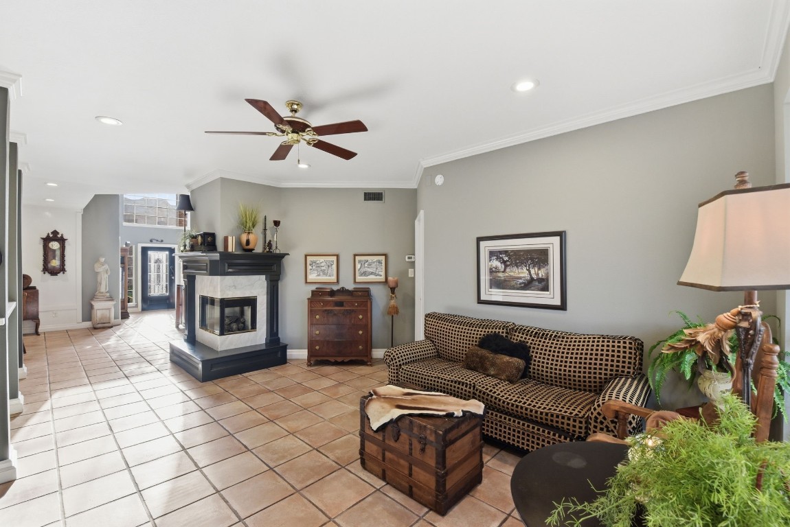 16322 Cranwood Drive Spring, TX 77379 - Photo 12 of 42 Experience cozy elegance with this inviting space featuring a stunning double-sided gas fireplace and charming corner mantle, perfect for warmth and style.