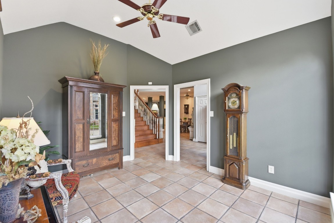 16322 Cranwood Drive Spring, TX 77379 - Photo 7 of 42 This inviting room features elegant tile flooring, seamlessly connected to the foyer through two stylish doors, enhancing the home's welcoming flow.
