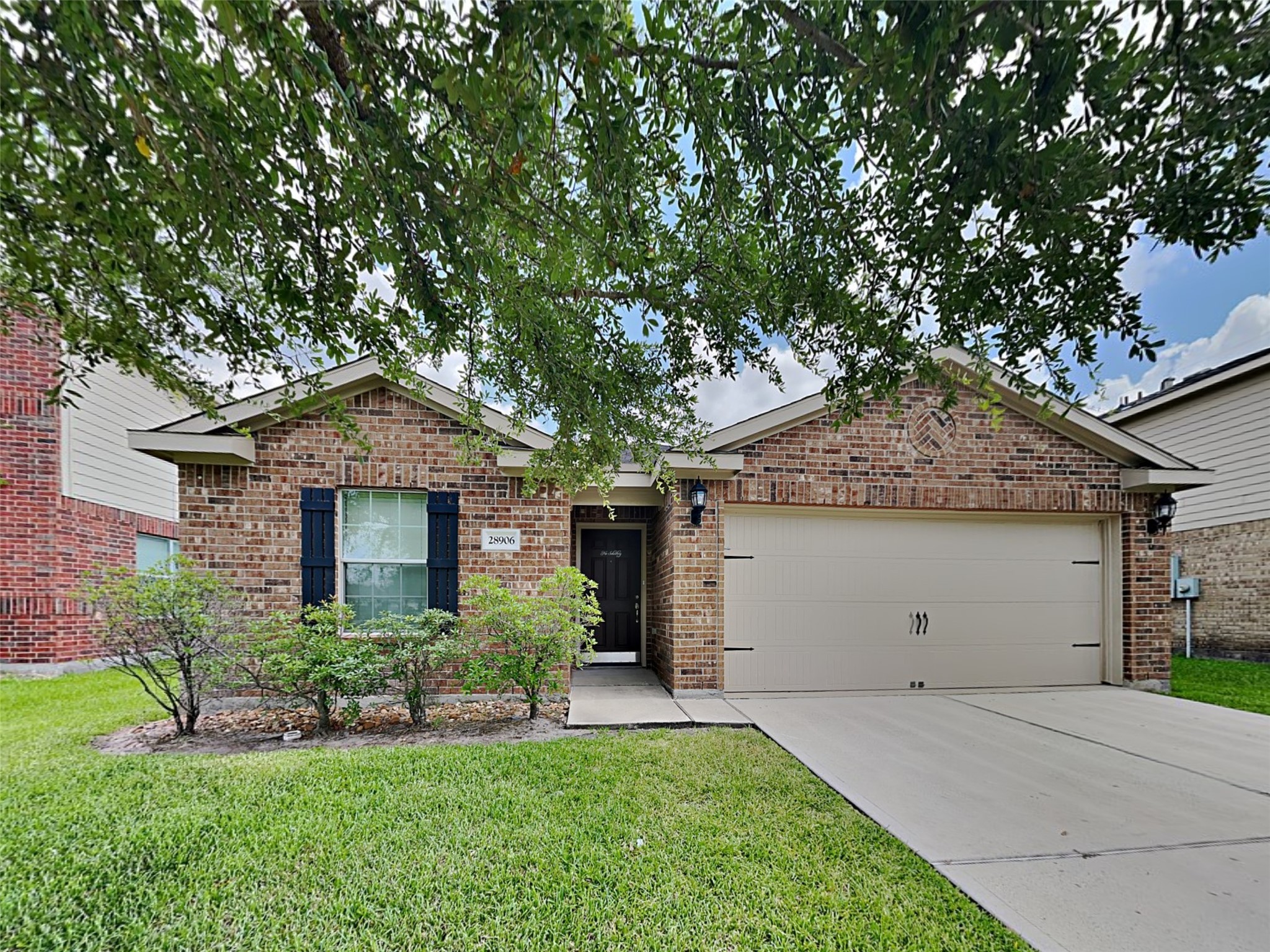 a front view of house with a garden
