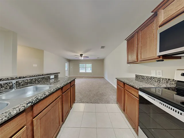 a kitchen with a refrigerator and a sink