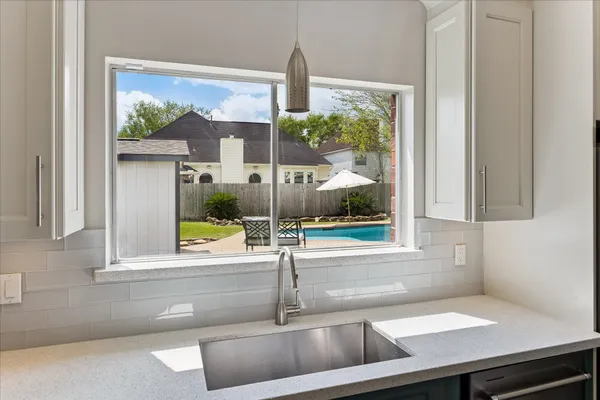 a kitchen with stainless steel appliances granite countertop a sink a stove and a microwave