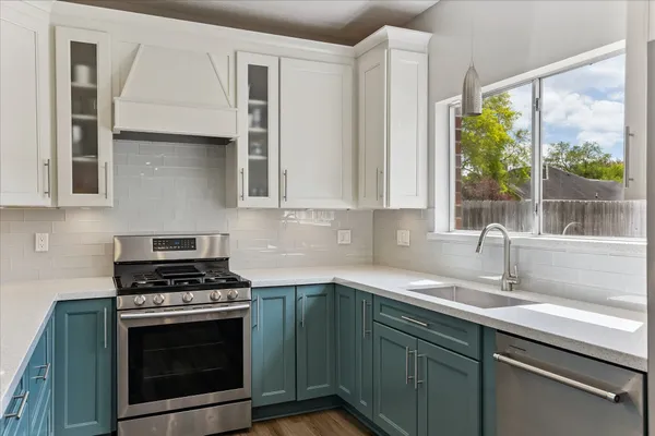 a kitchen with stainless steel appliances granite countertop a stove and a refrigerator