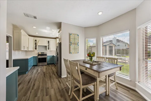 a kitchen with stainless steel appliances granite countertop a refrigerator and microwave