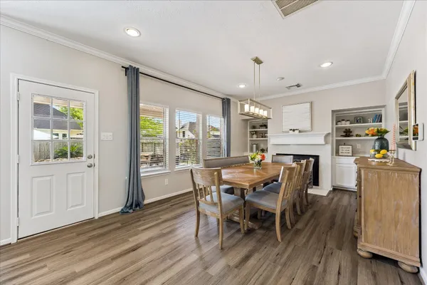a view of a a dining room with furniture and wooden floor