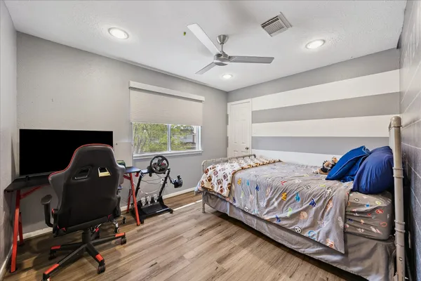 a bedroom with a bed and a desk