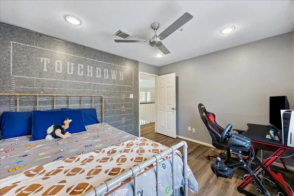 a bedroom with a bed and a flat screen tv