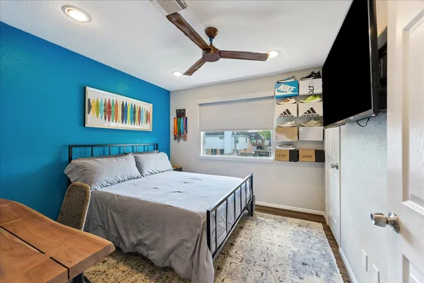a bedroom with a bed and a flat screen tv