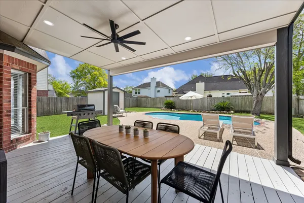 a view of a house with swimming pool and sitting area