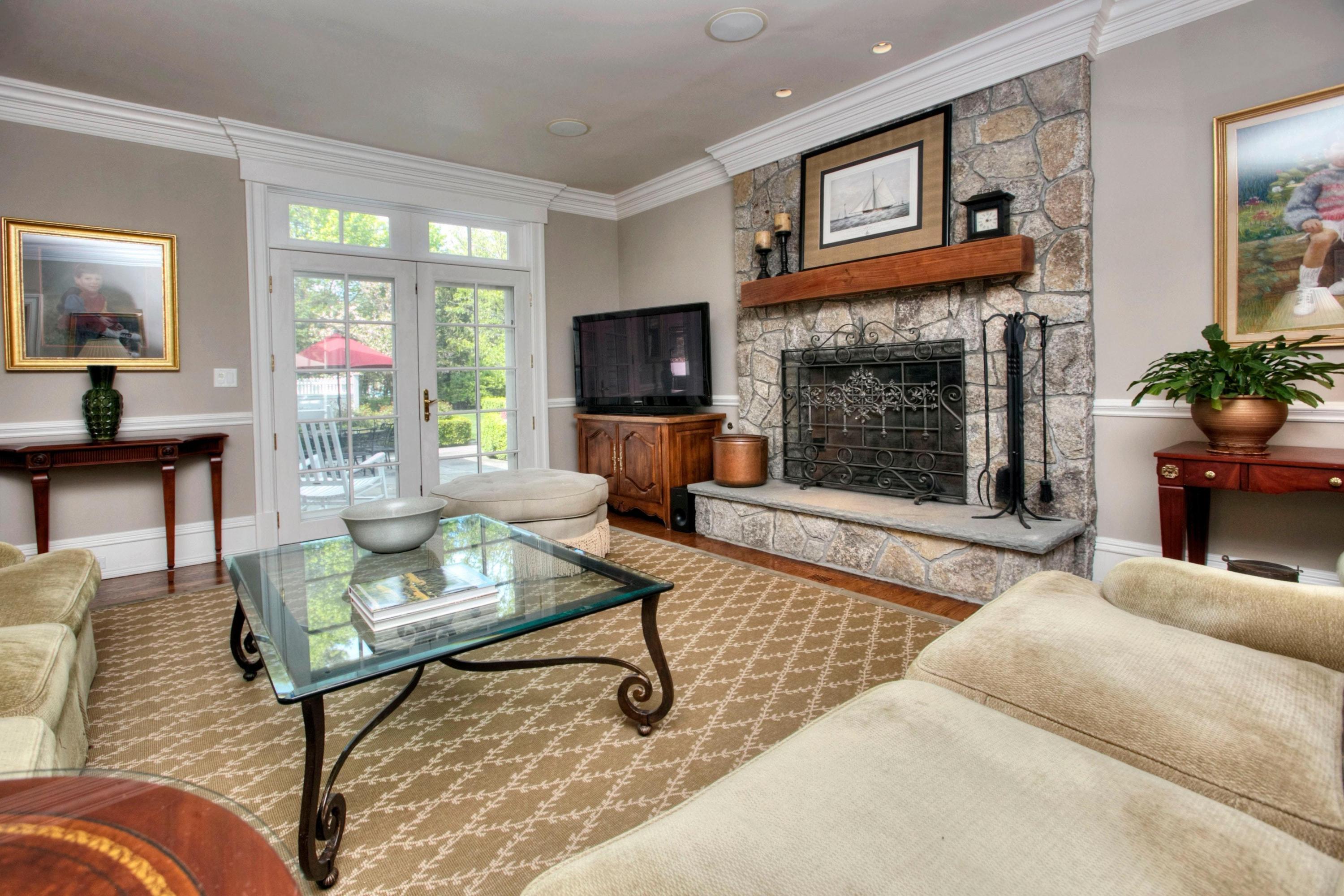 1325 Smith Ridge Road New Canaan, CT 06840 - Photo 11 of 28 a living room with furniture a flat screen tv and a fireplace