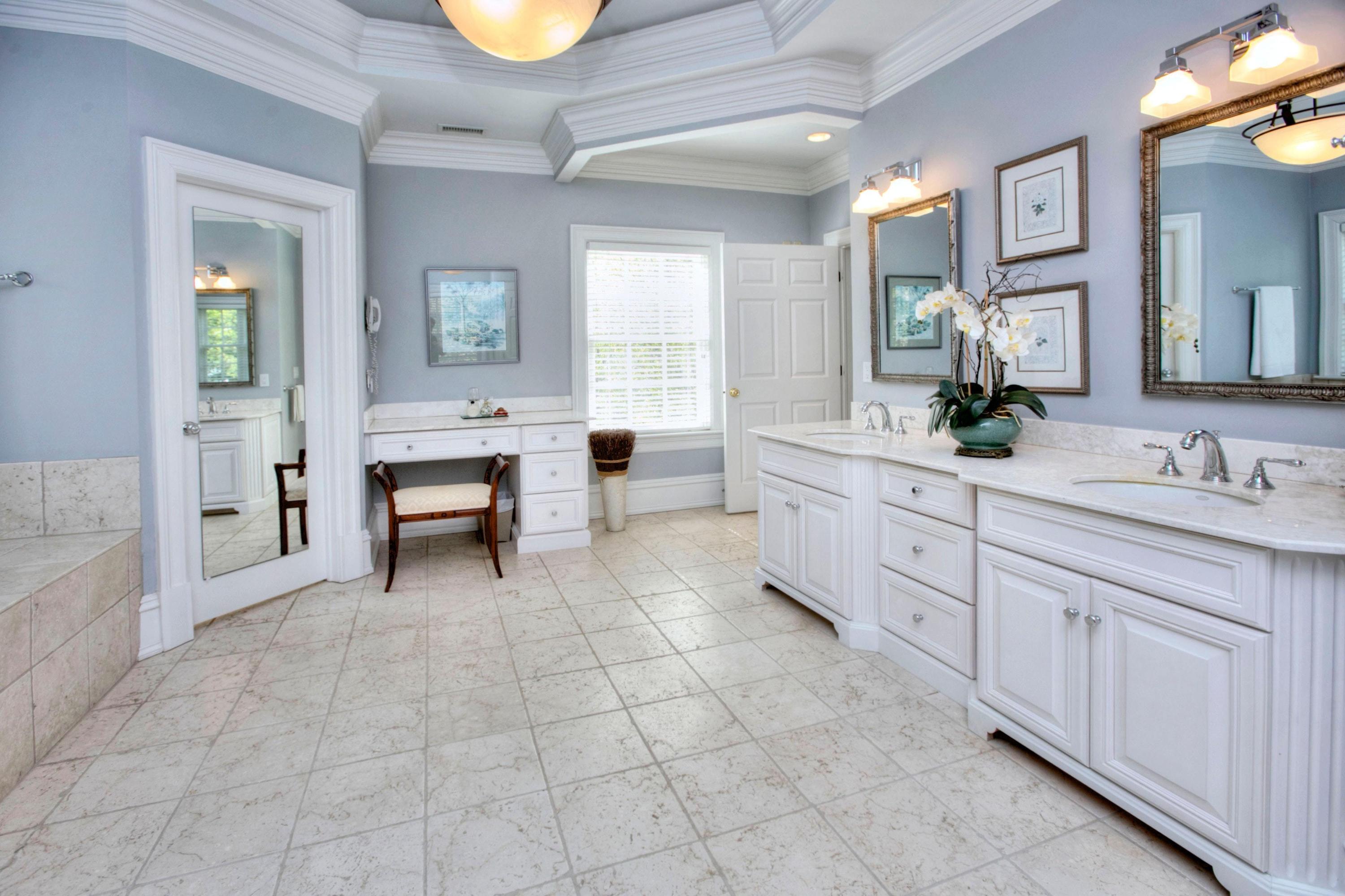 1325 Smith Ridge Road New Canaan, CT 06840 - Photo 15 of 28 a spacious en suite bathroom with a double vanity sink a mirror and a bathtub