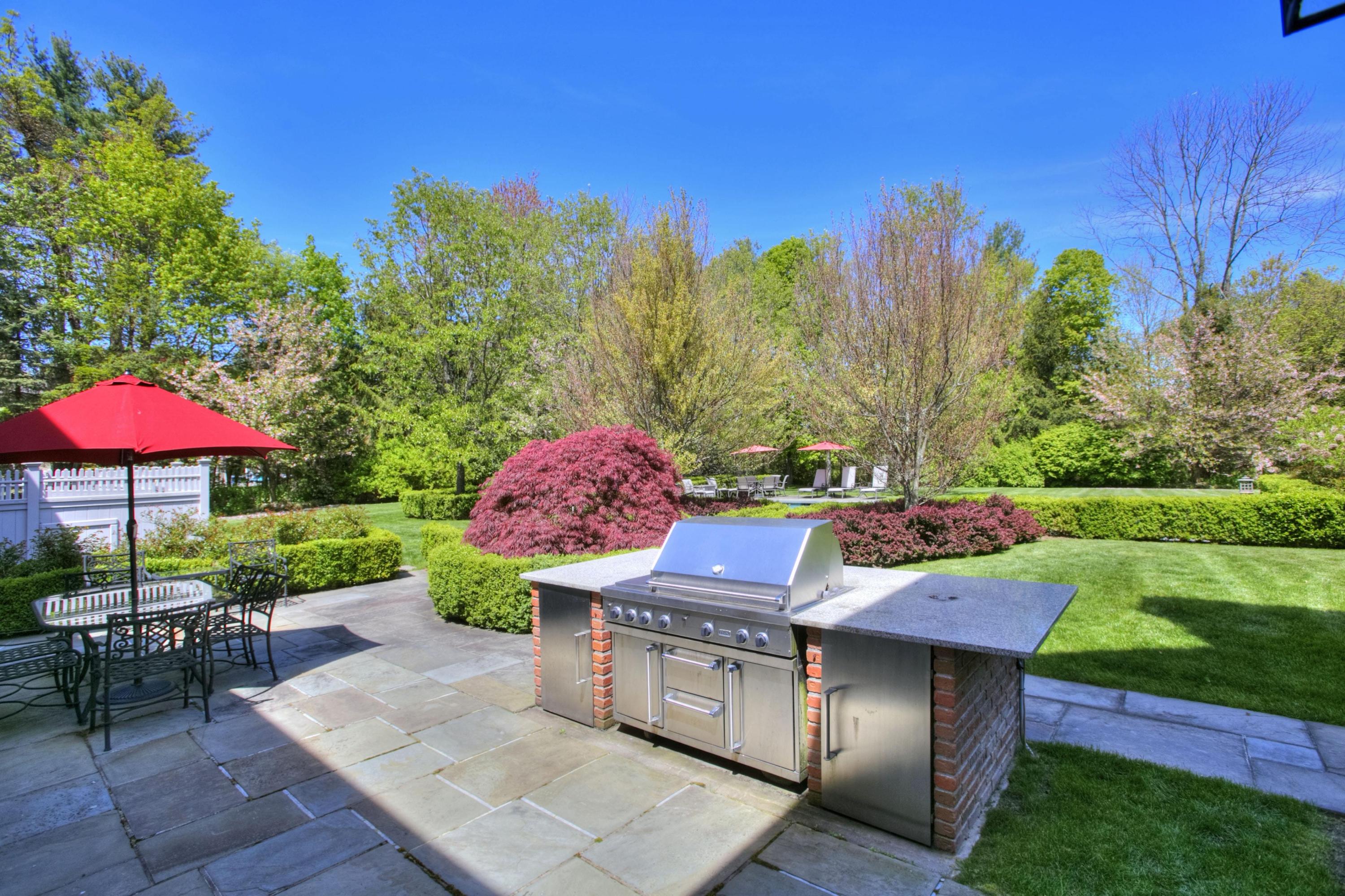 1325 Smith Ridge Road New Canaan, CT 06840 - Photo 21 of 28 an outdoor space with furniture and umbrella