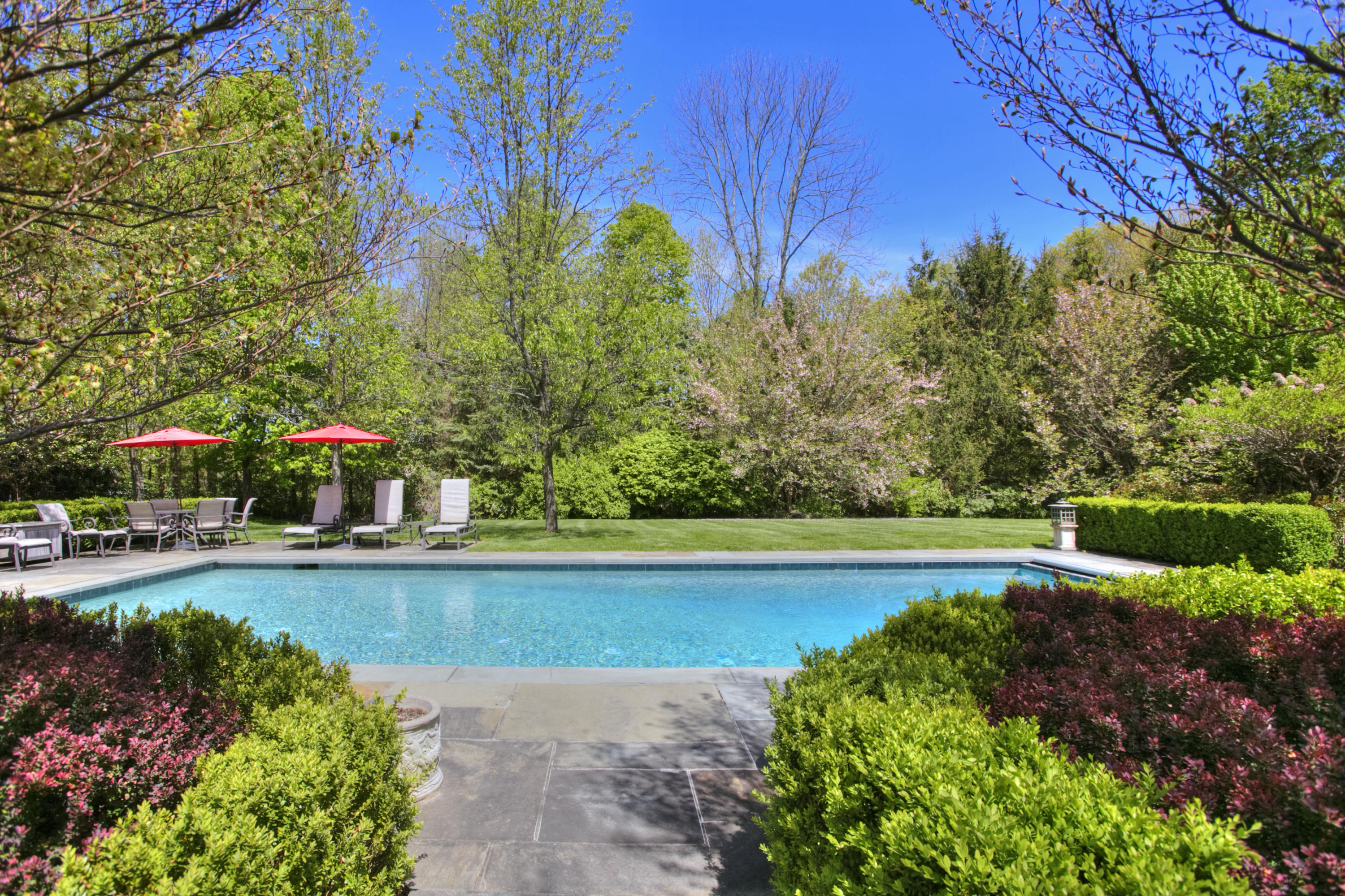 1325 Smith Ridge Road New Canaan, CT 06840 - Photo 25 of 28 a view of a swimming pool next to a yard