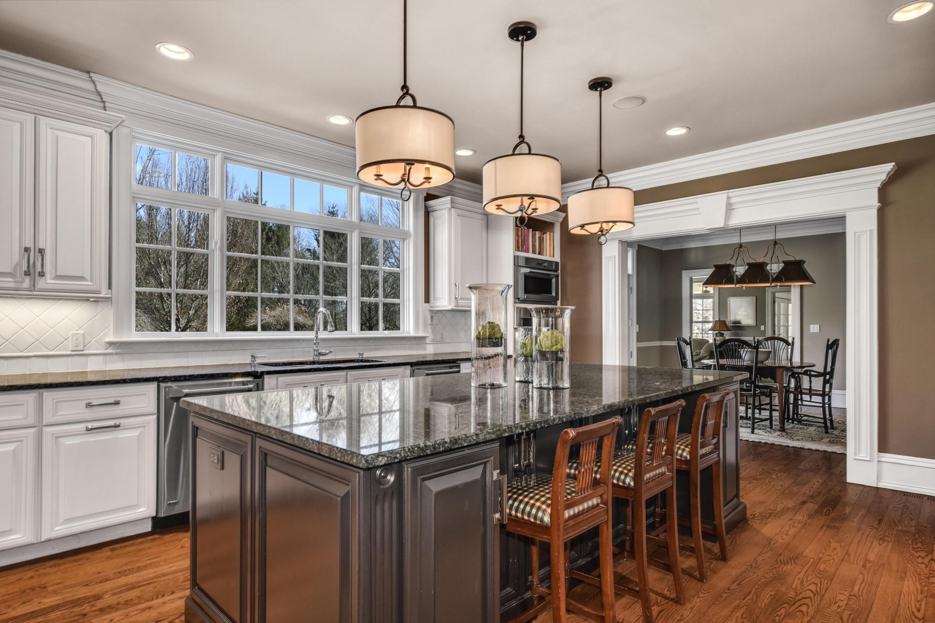 1325 Smith Ridge Road New Canaan, CT 06840 - Photo 8 of 28 a kitchen with stainless steel appliances granite countertop a stove and chandelier