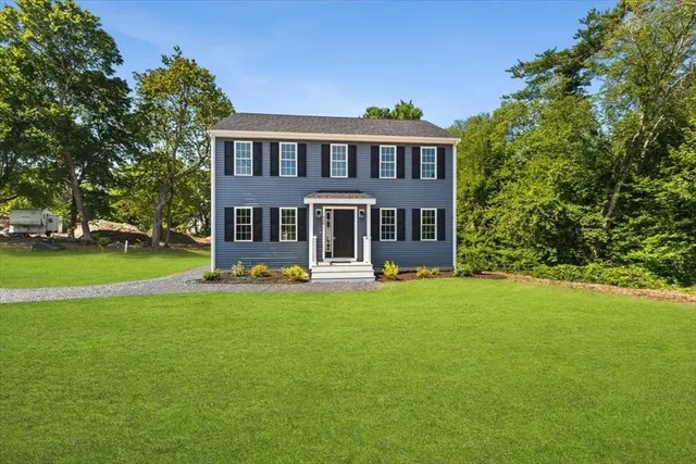 a front view of a house with yard patio and green space