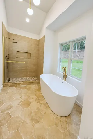 a bathroom with a bathtub and shower