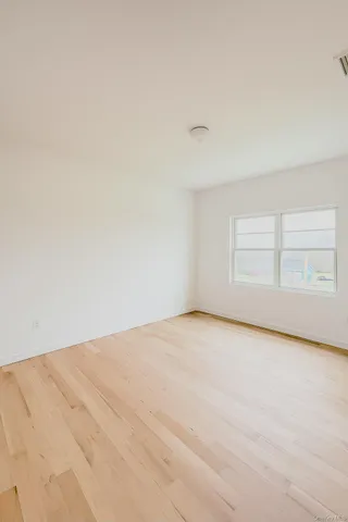 a view of an empty room and a window