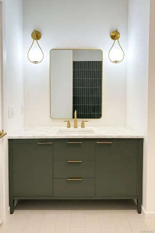 a bathroom with a sink and mirror