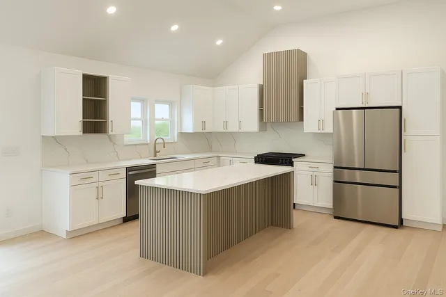 a kitchen with a sink stove and refrigerator