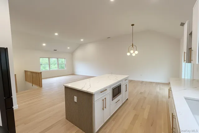a kitchen with a stove and a wooden floor