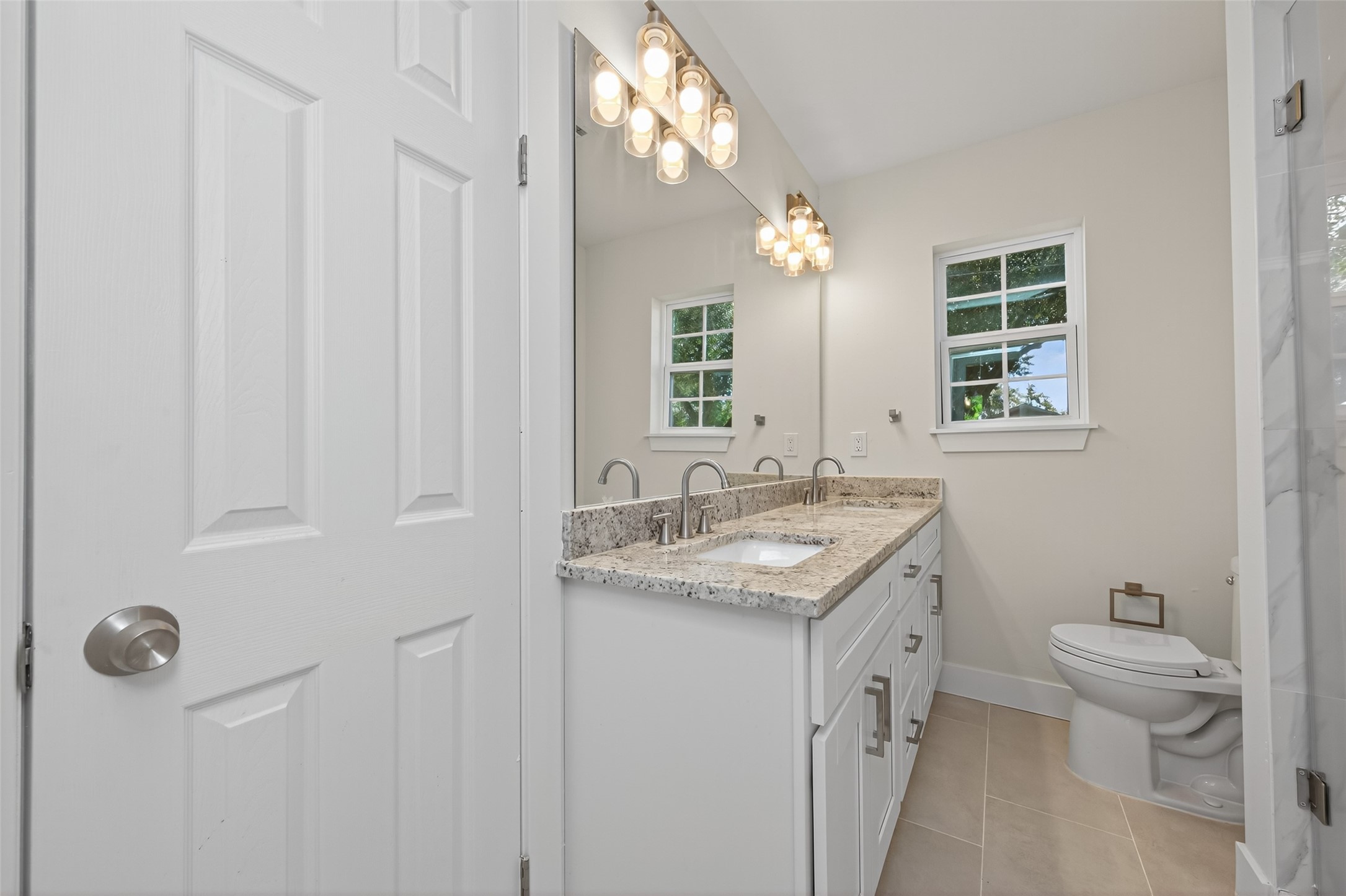 1418 Carlisle Street Rosenberg, TX 77471 - Photo 12 of 49 a bathroom with a granite countertop sink a toilet and a mirror
