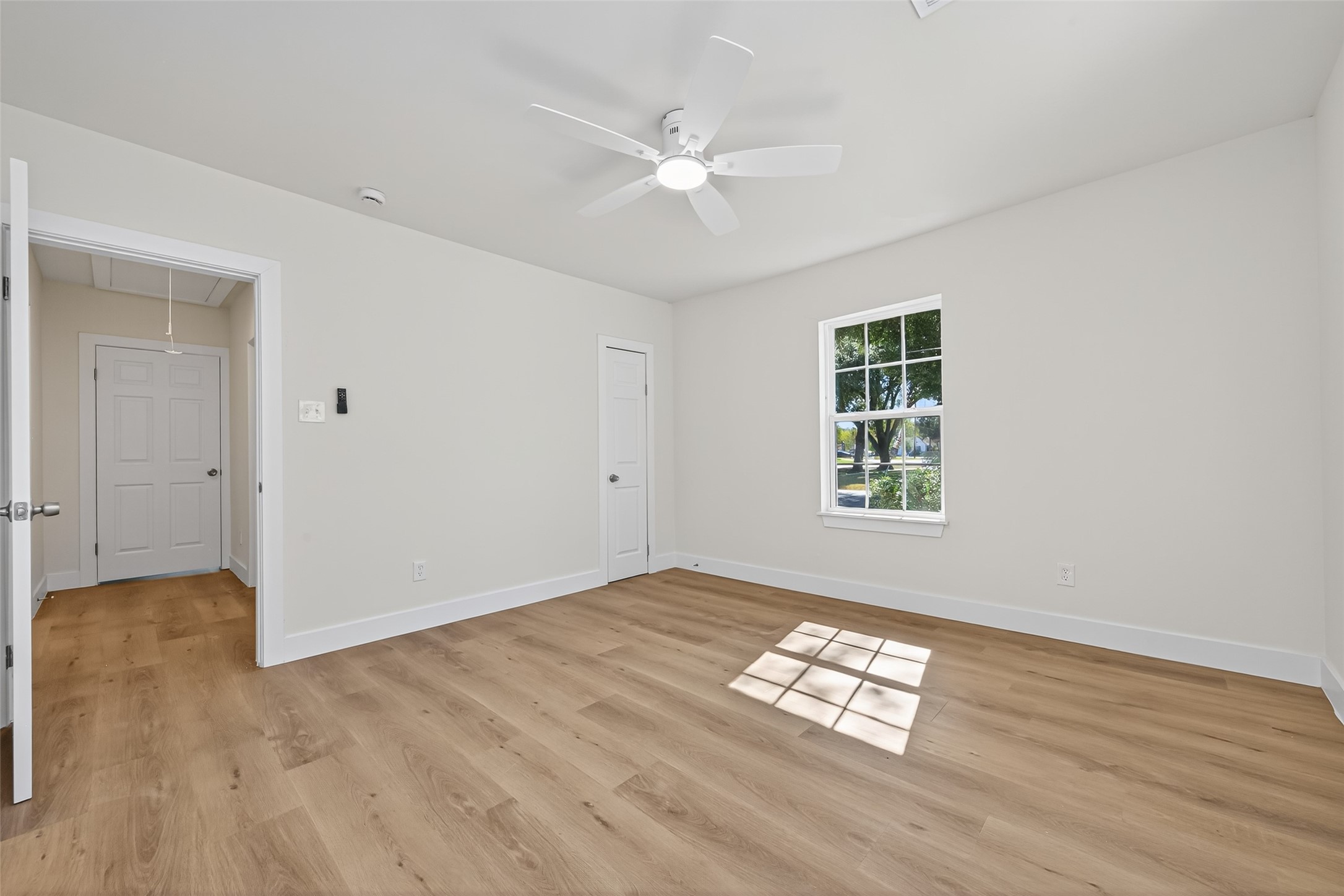 1418 Carlisle Street Rosenberg, TX 77471 - Photo 15 of 49 an empty room with wooden floor chandelier fan and windows