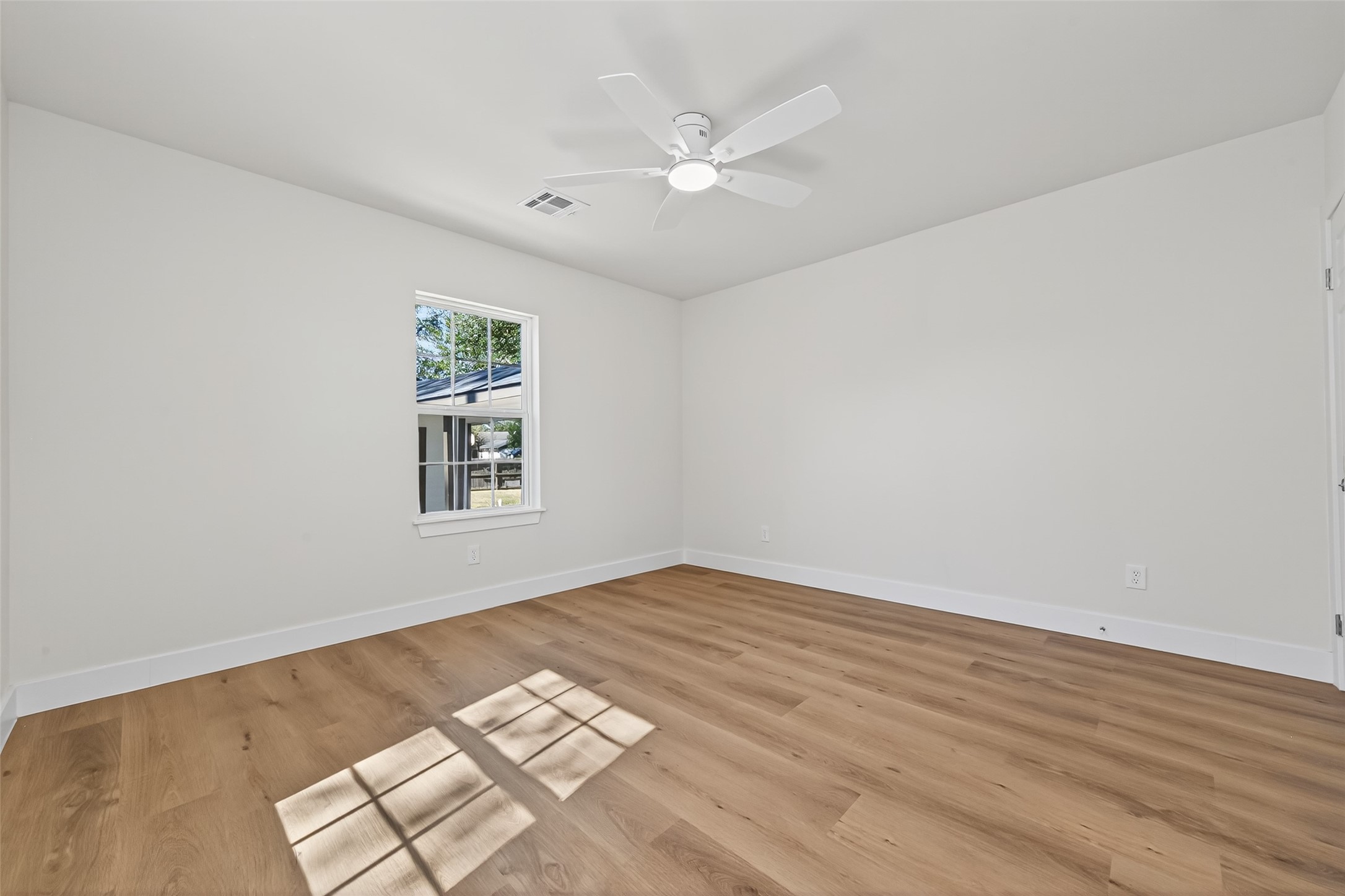 1418 Carlisle Street Rosenberg, TX 77471 - Photo 16 of 49 an empty room with wooden floor and windows