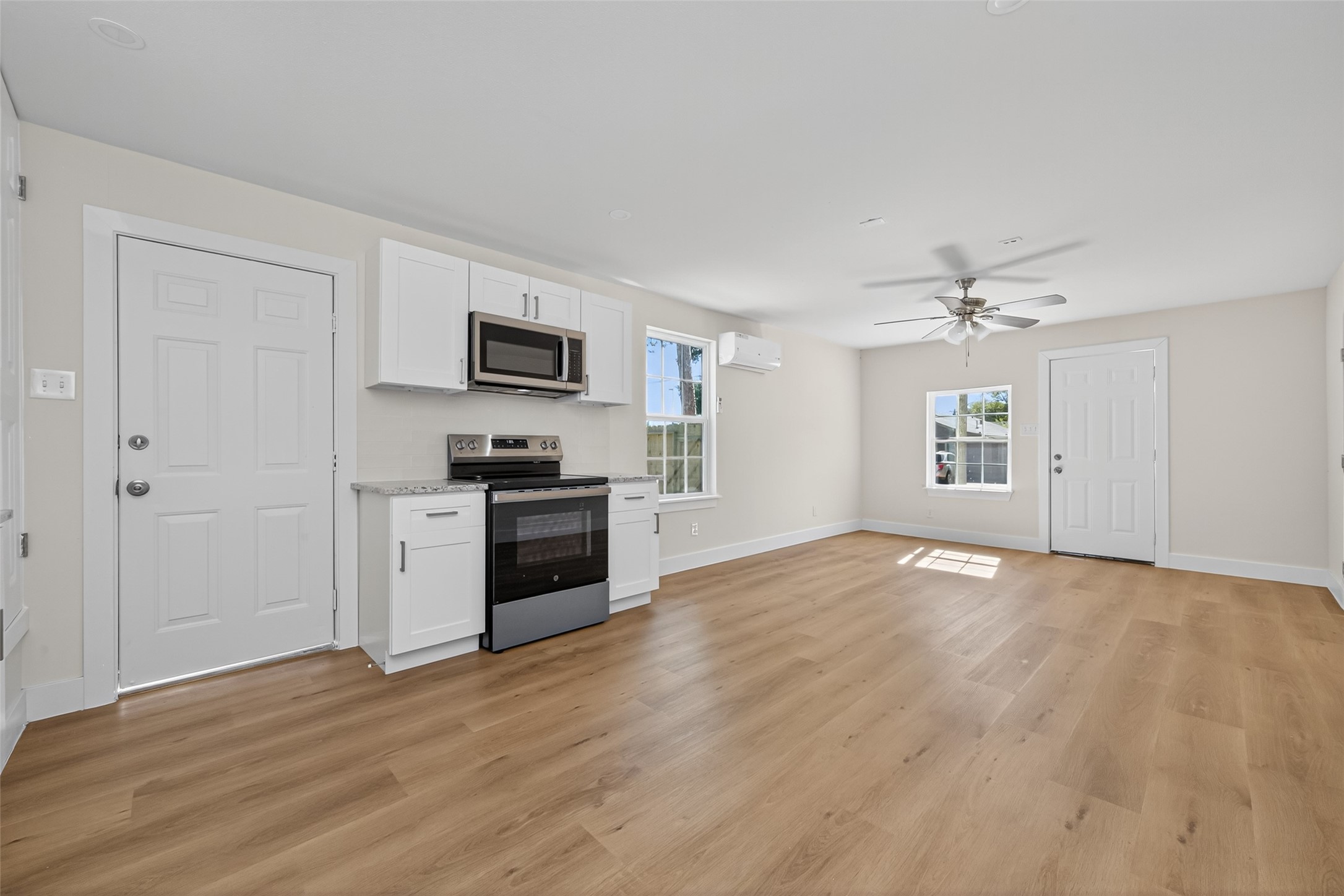 1418 Carlisle Street Rosenberg, TX 77471 - Photo 19 of 49 a kitchen with granite countertop a refrigerator and a stove top oven