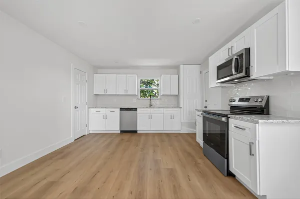 a kitchen with stainless steel appliances a refrigerator sink and microwave