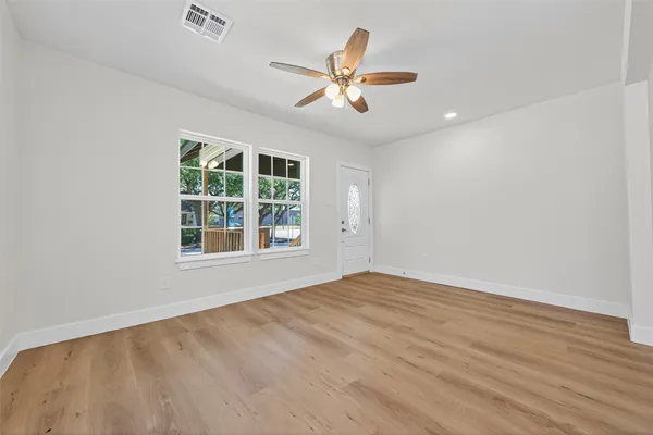 wooden floor in an empty room with a window